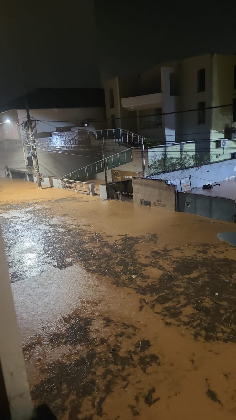 Streets of Ubá completely submerged in floodwaters at night